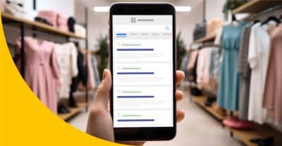 Das Bild zeigt ein Smartphone in einem Kleidungsgeschäft, das veranschaulicht, wie es ausschaut, wenn man bei Bing Unternehmen eintragen lässt.